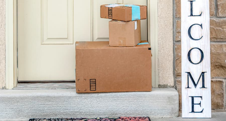 Boxes by the door of a residence with a welcome sign in Trenton